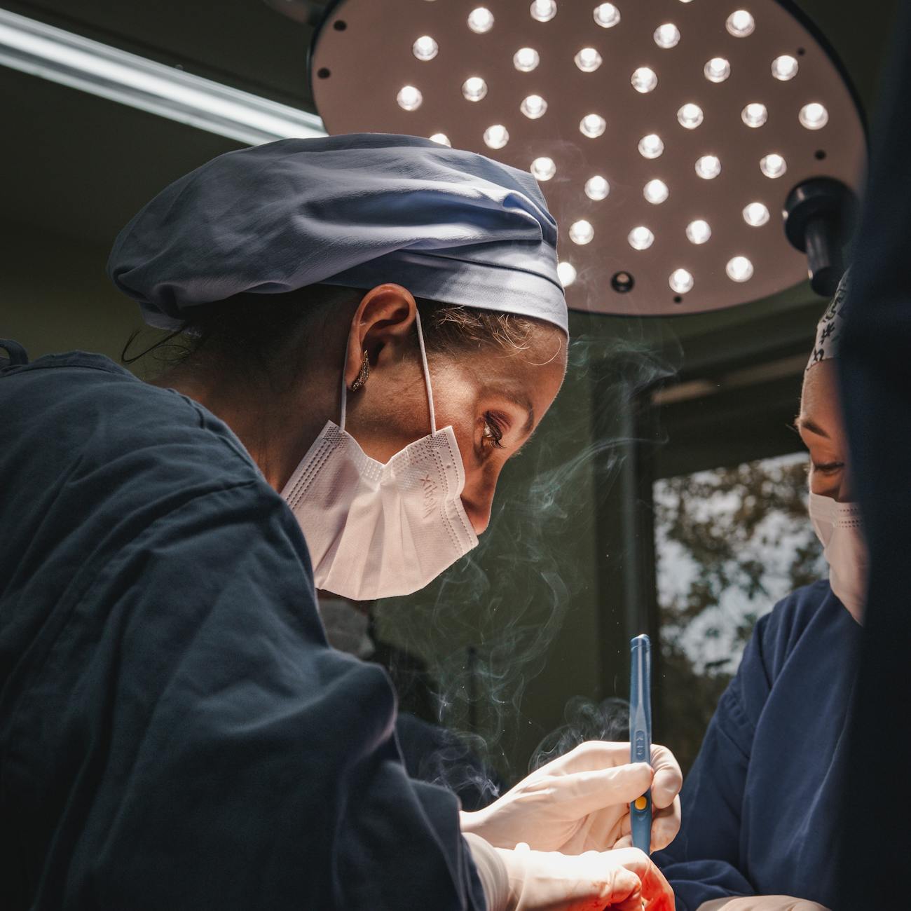 surgeon working in hat and gloves