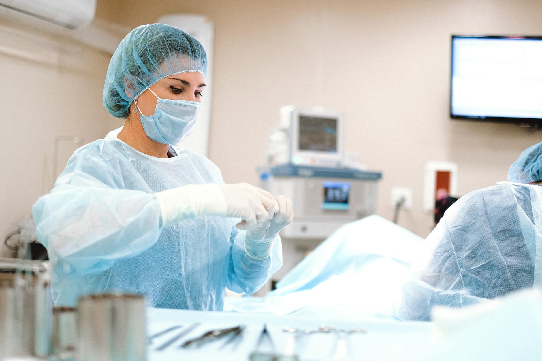 woman in blue dress shirt wearing blue mask and white latex gloves